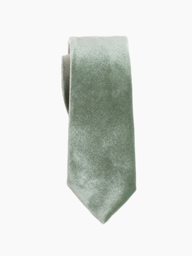 A green velvet tie with a smooth texture.