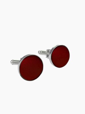 A pair of stylish cinnamon - colored cufflinks with a shiny finish.