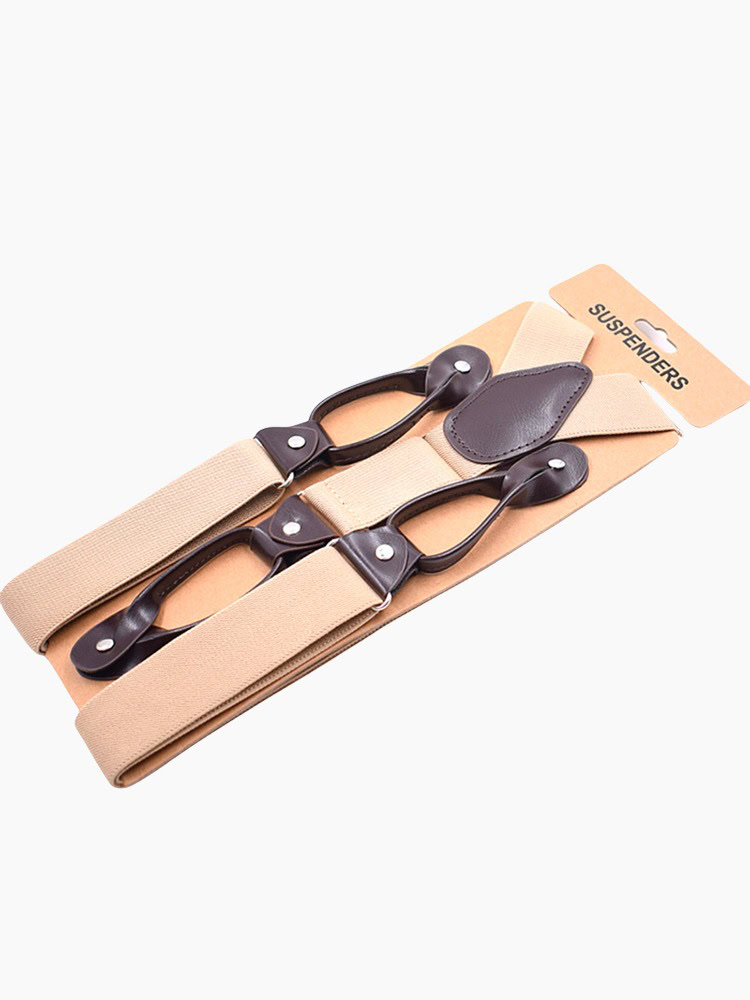 A pair of champagne - colored elastic suspenders with black leather - like clips and adjusters.