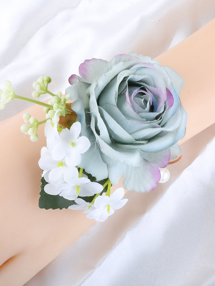 Ombre blue rose wrist corsage with white small flowers and a pearl bracelet