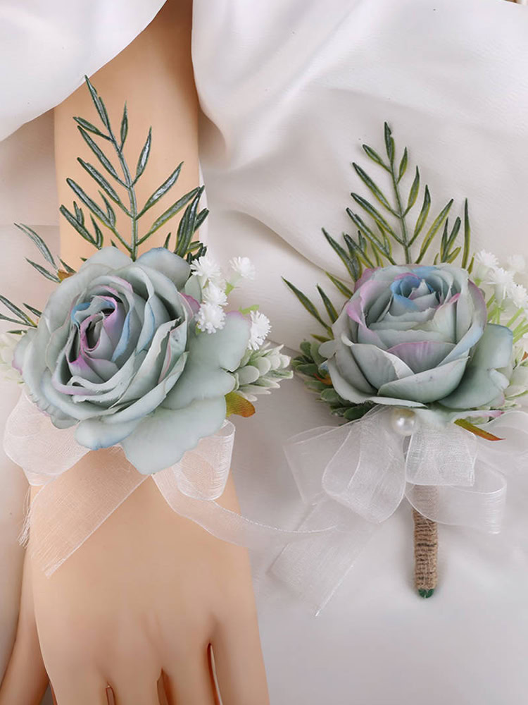 Ombre blue rose boutonniere and wrist corsage set with green foliage and white ribbons
