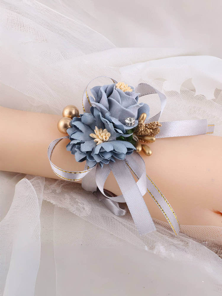 Light blue floral wrist corsage with gold accents and gray ribbons