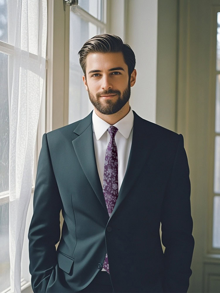 Man in a suit wearing a deep purple floral patterned tie