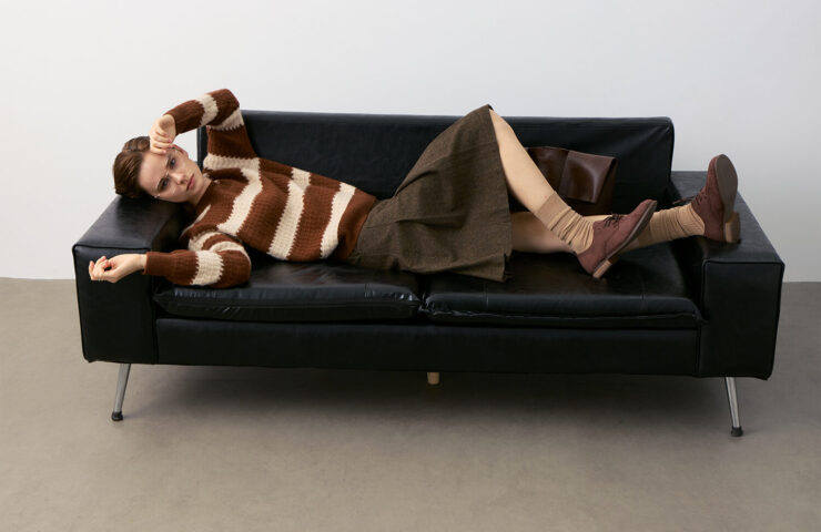 Striped Cashmere Sweater Model on Black Leather Sofa - Polished Casual Style