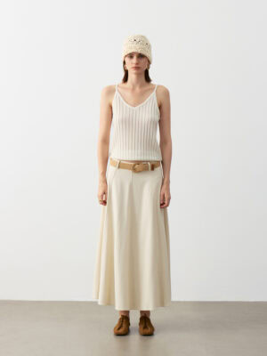 Model Wearing 100% Cashmere V-Neck Ribbed Camisole with Beige Maxi Skirt, Brown Belt, Knit Beanie, and Brown Shoes