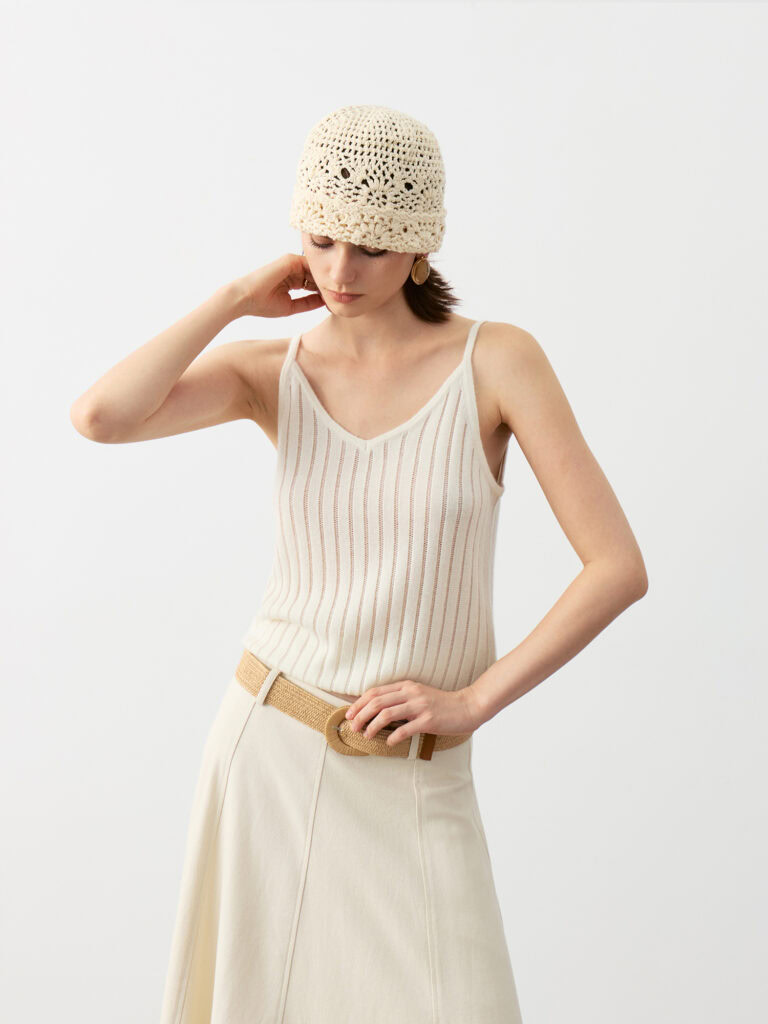 Model Wearing 100% Cashmere V-Neck Ribbed Camisole with Beige Maxi Skirt, Brown Belt, Knit Beanie, and Brown Shoes